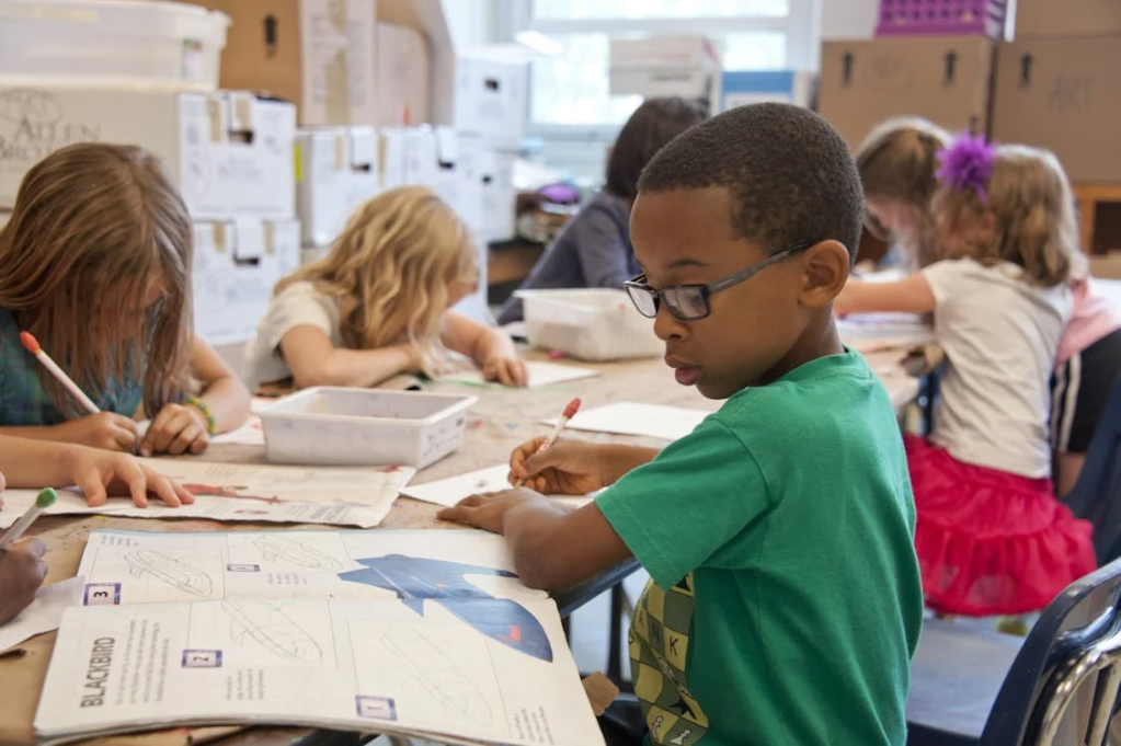 Photo of children reading and writing in the classroom. Photo Credit: The Centers for Disease Control.